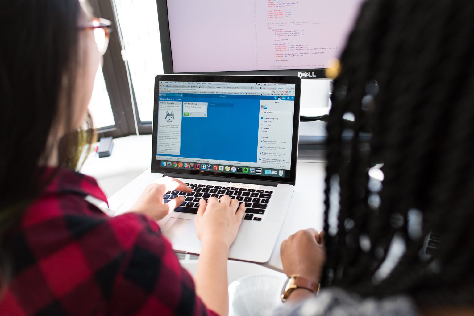 An IT technology support representative assisting someone with their computer.